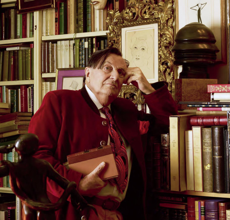 Barry Humphries in his library